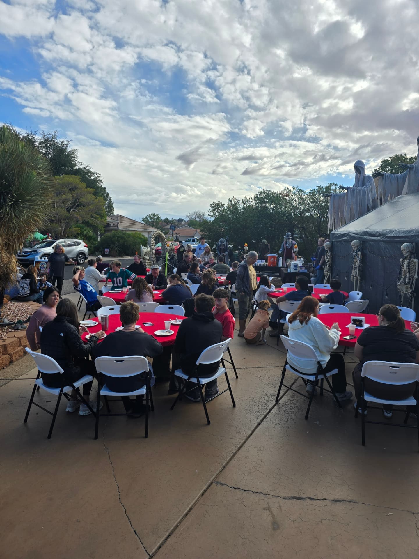 Neighbors filling the red-covered tables for breakfast.
